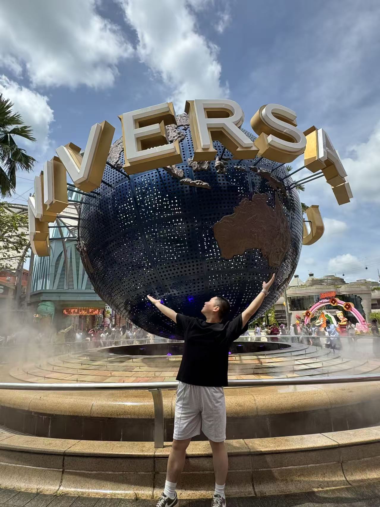 Qihao Yang in front of the Universal globe